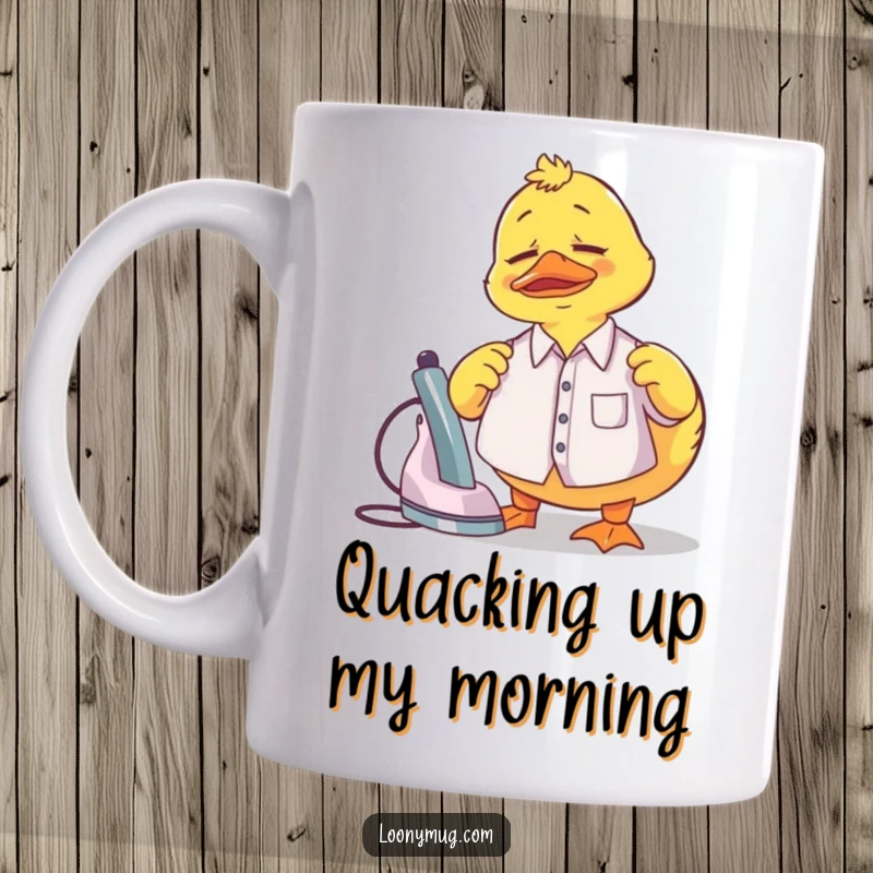 Funny Mug showing a confused rubber duck struggling to iron a miniature shirt, embodying laundry day woes.