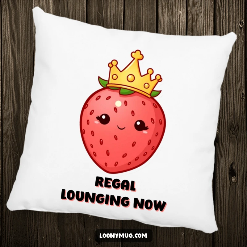 Funny pillow with a plump strawberry wearing a tiny crown, looking imperious, offering soft comfort and a regal touch.