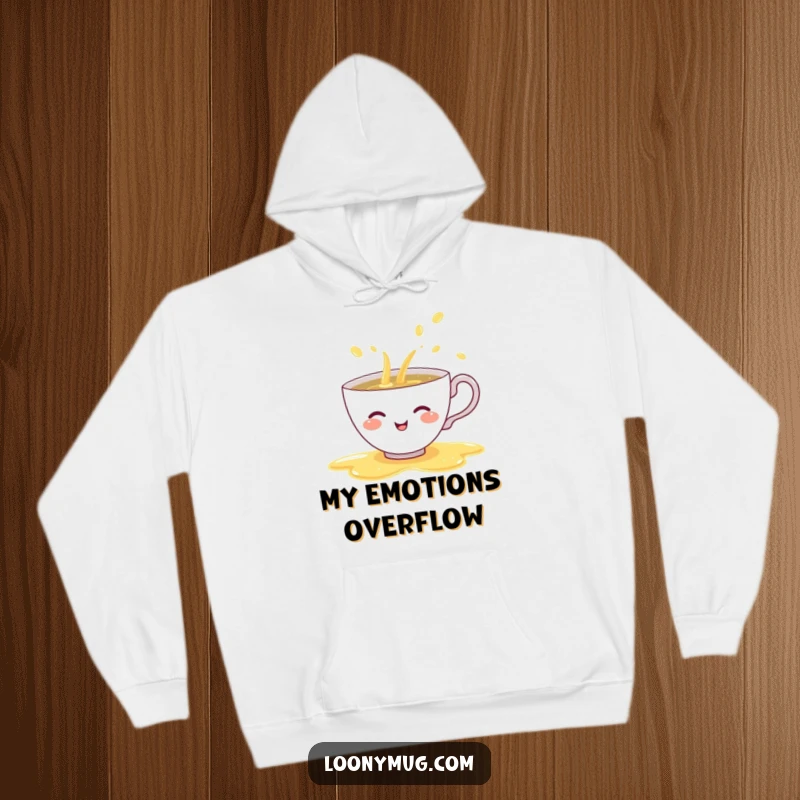 Funny hoodie print of a shy teacup giggling as it spills a rainbow of tea, ideal for comfortable and whimsical wear.