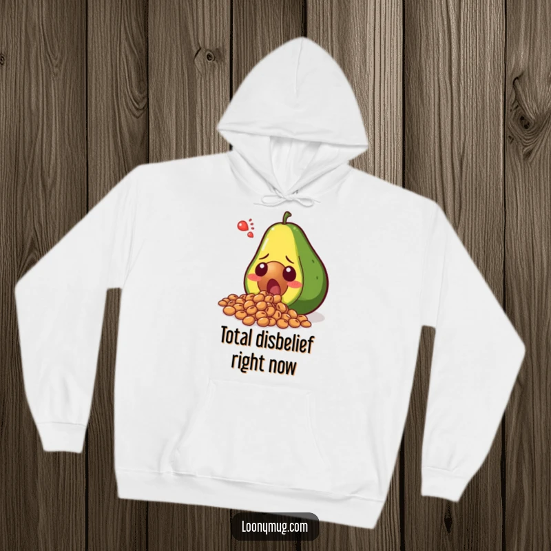 Funny shocked avocado spilling its seeds in disbelief, printed on a cozy hoodie. A humorous and warm clothing choice for avocado fans.