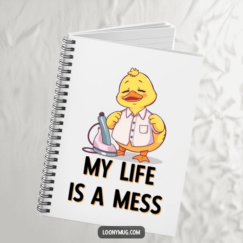 Funny Notebook cover with a confused rubber duck attempting to iron a tiny shirt, perfect for notes.