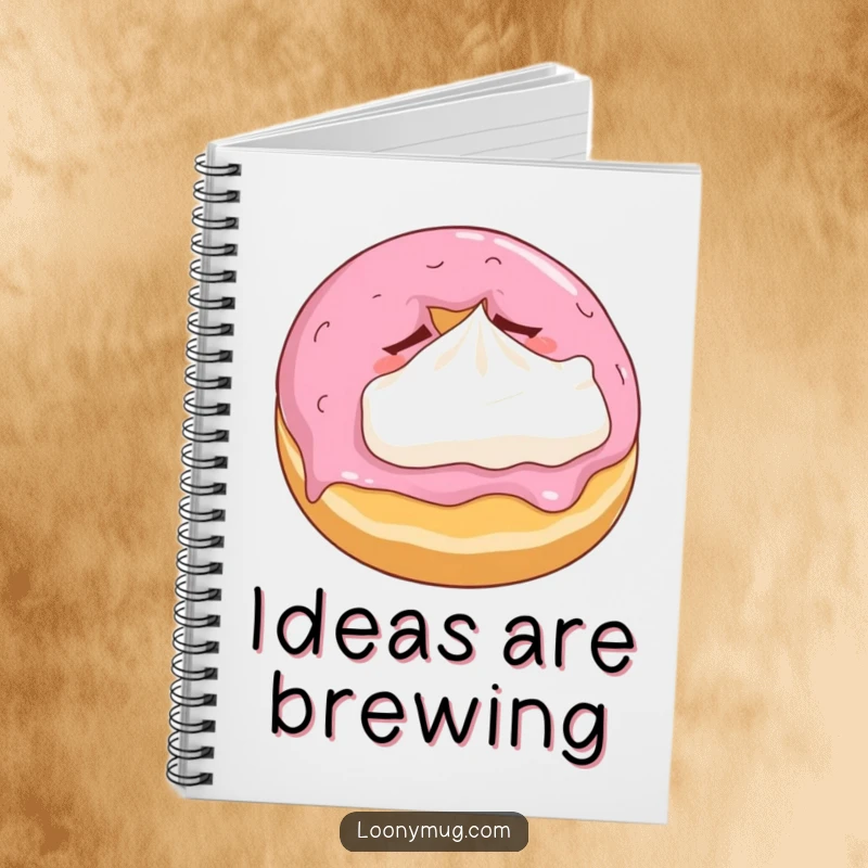 Funny notebook cover with a sleepy donut cuddling a tiny whipped cream pillow, perfect for note-taking.