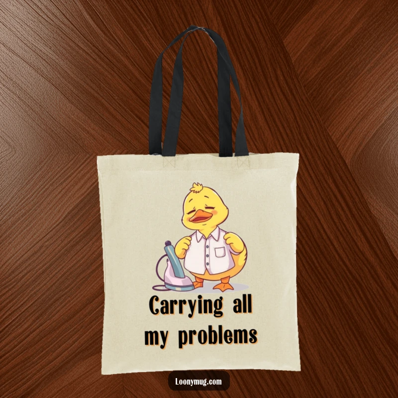 Funny Tote Bag featuring a confused rubber duck attempting to iron a tiny shirt, perfect for laundry day.