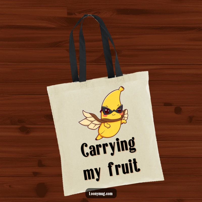 Funny tote bag showcasing a determined flying banana wearing a cape, ready for any adventure.